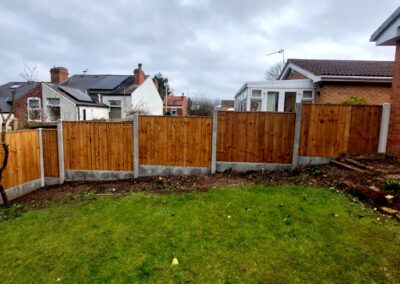Concrete and wood garden fencing by SG Landscaping